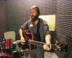 Ray Riddle playing a guitar
