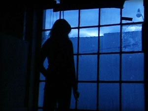 photo of a woman looking out a window