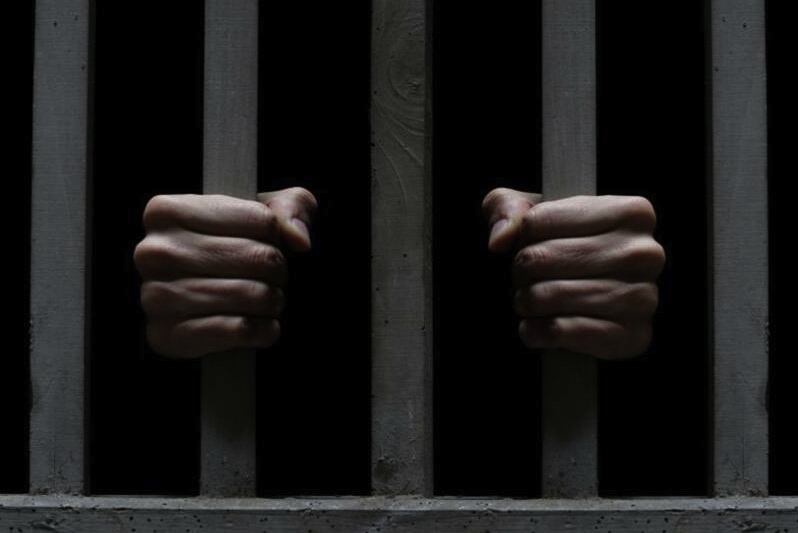PrisonBarsFists.jpg